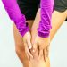 how to save your knees without giving up your workout - featured image of runner holding her knee in pain.