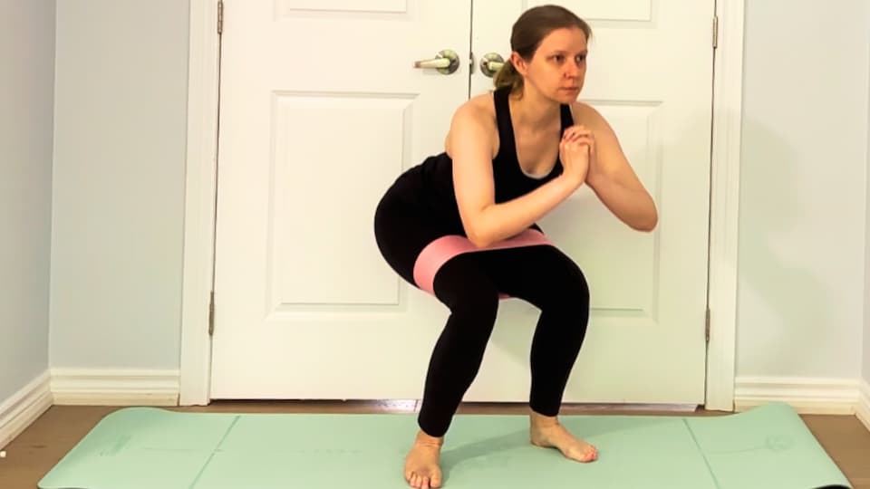 best booty band for glutes feature image - me performing a banded squat